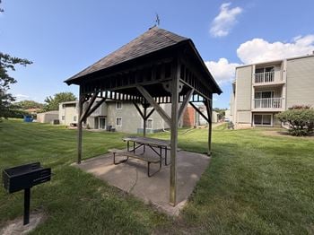 Covered picnic shelter with table and grill